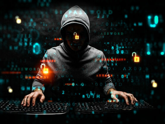 Hacker with his hands on two keypads, on digital code dark background