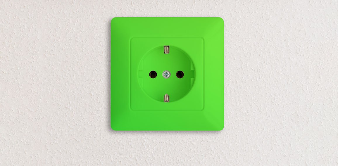 green electrical socket on white wall