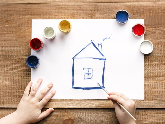 Kind malt Haus mit Pinsel