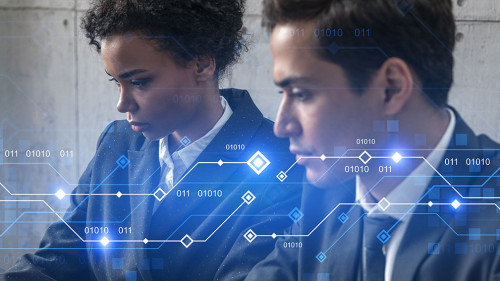 Two good looking businesspeople working together in office on IT project. Technology hologram drawings. Double exposure. Formal wear.