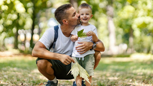Summer time for family fun in the wood. Father and son dressed i