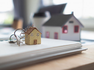 Real estate sales documents and model homes are placed on tables