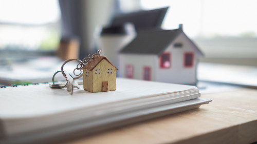 Real estate sales documents and model homes are placed on tables