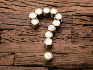 Stacked Coins Forming Question Mark