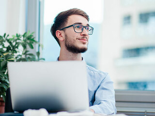 Young businessman in office working on laptop