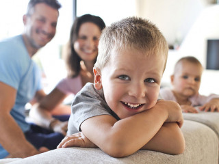 Smiling kids with their parents in the living room