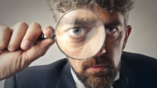 Man using a magnifier