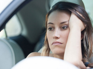 Bored woman waiting patiently in her car