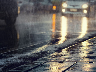 Hard rain fall in the city with blurry cars .Selective focus.