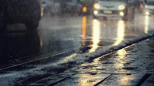 Hard rain fall in the city with blurry cars .Selective focus.