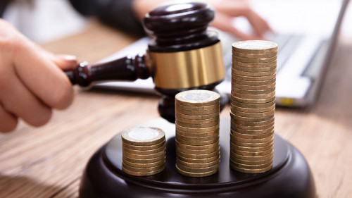 Stack Of Increasing Coins On Gavel At Workplace