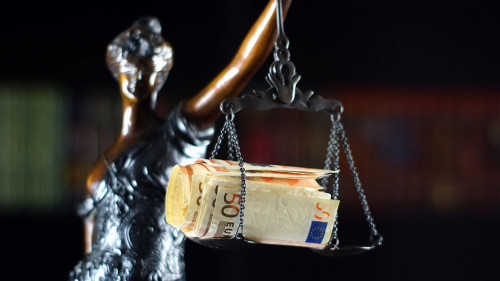 Statue of the goddess Themis with bribe on libra