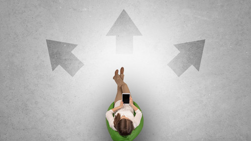 Woman sitting in office with device an her hand