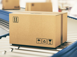 Cardboard boxes on conveyor rollers ready to be shipped by courier for distribution