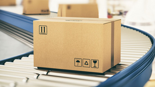 Cardboard boxes on conveyor rollers ready to be shipped by courier for distribution