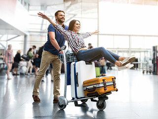 Happy smiling couple having fun at airport