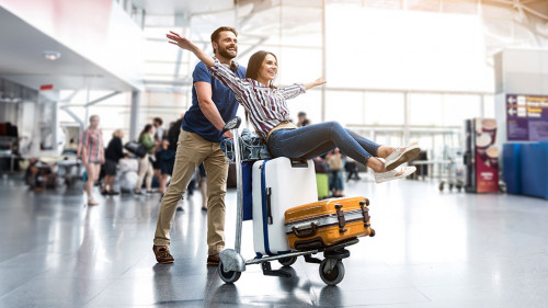 Happy smiling couple having fun at airport