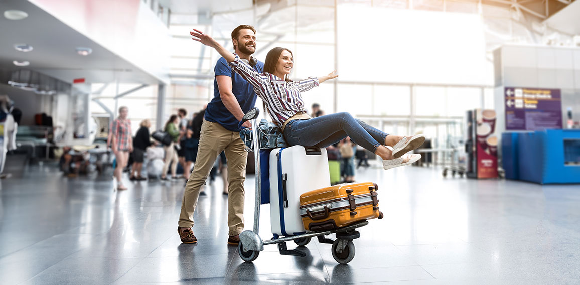 Happy smiling couple having fun at airport
