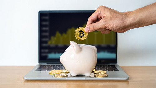 Hand businessman is putting Golden Cryptocurrency bitcoin in a c