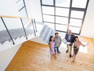 Real estate agent showing new house to couple
