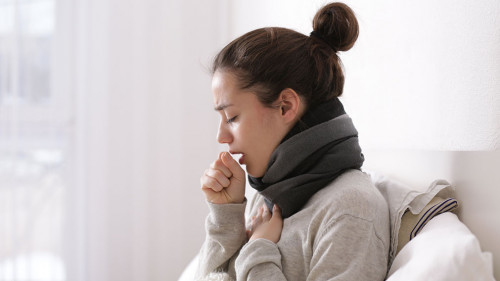 Young ill woman in bed at home
