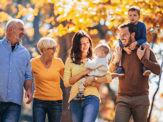 Multl generation family in autumn park having fun