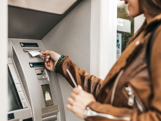 Close up shot of young adult woman. He typing pin code on keypad