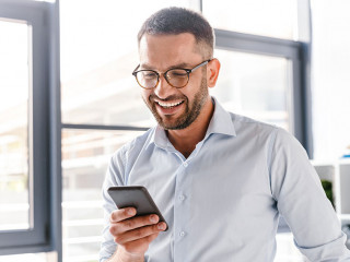 Image closeup of smiling employer guy in white shirt standing in