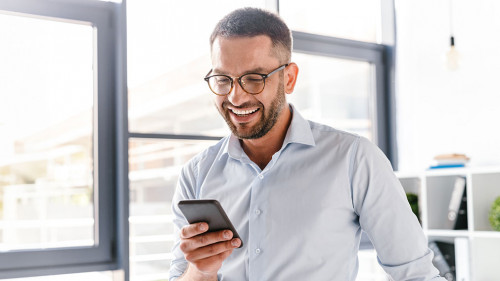 Image closeup of smiling employer guy in white shirt standing in