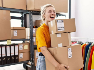 Young blonde woman working at small business ecommerce celebrating crazy and amazed for success with open eyes screaming excited.