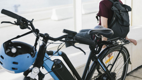 Close up electric bicycle with sitting man in background