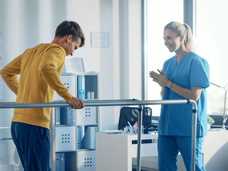 Hospital Physical Therapy Room: Strong Patient with Injury Walki