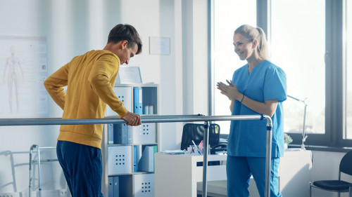 Hospital Physical Therapy Room: Strong Patient with Injury Walki