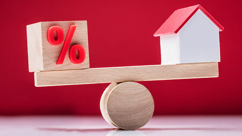 Seesaw Showing Balance Between Percentage Symbol And House Model