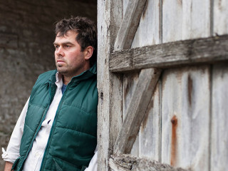 farmer standing in barn