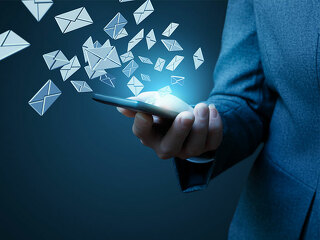 Anzugtraegerin-Smartphone-Emails-203557688-FO-natali-mis