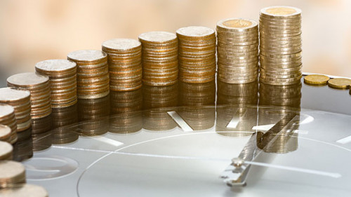 Muenzstapel-auf-Uhr-283640727-AS-redkphotohobby