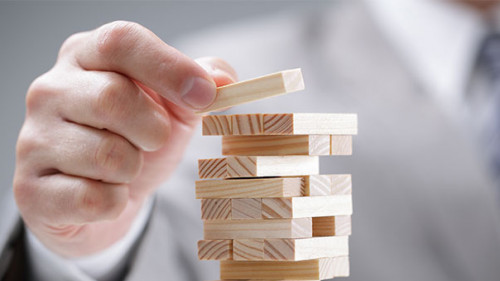 Anzugtraeger-Holzkloetze-Turm-79893140-AS-Brian-Jackson