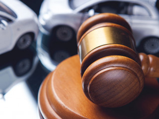 Model of car and gavel. Accident lawsuit or insurance, court cas