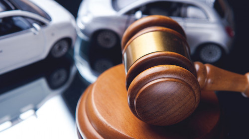 Model of car and gavel. Accident lawsuit or insurance, court cas