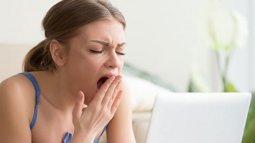 Frau-Laptop-gaehnen-169907288-AS-fizkes