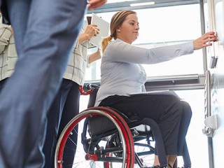 Anzugtraeger-Rollstuhl-Aufzug-310173813-AS-Robert-Kneschke