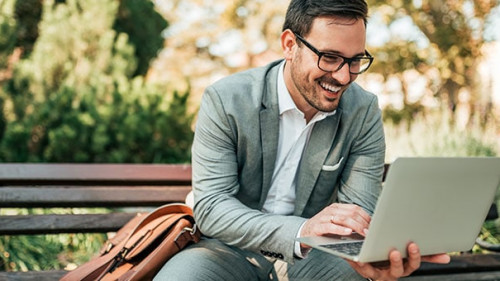 Anzugtraeger-Laptop-Parkbank-229647638-AS-bnenin