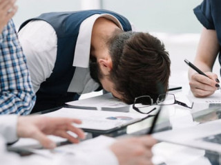 tired employee at a business meeting in the office