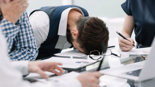 tired employee at a business meeting in the office