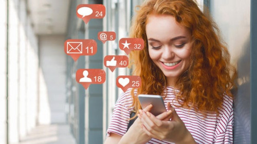 Blogger using phone with social media notification icons