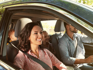 Happy family in car on road trip