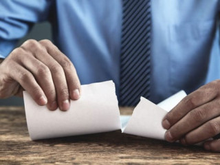 Businessman tearing contract.