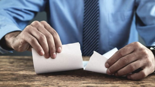 Businessman tearing contract.