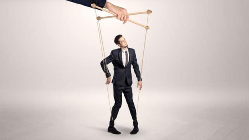 Puppet businessman leaded by a huge hand